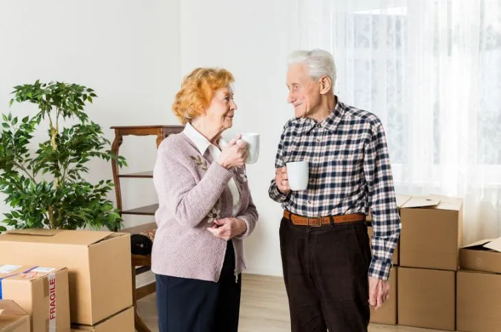 Happy elderly couple after move